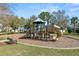 Community playground featuring slides, climbing structures, and a cushioned play area at 4446 Wildstar Cir, Wesley Chapel, FL 33544