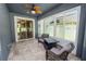 Enclosed patio featuring tile floors and a ceiling fan, perfect for relaxation or entertaining at 4446 Wildstar Cir, Wesley Chapel, FL 33544