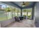 Bright sunroom featuring tile flooring, a ceiling fan, and lots of natural light at 4446 Wildstar Cir, Wesley Chapel, FL 33544