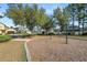 Community swings within a mulched playground area at 4446 Wildstar Cir, Wesley Chapel, FL 33544
