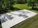 Outdoor sand volleyball court surrounded by lush greenery and well-maintained landscaping at 4446 Wildstar Cir, Wesley Chapel, FL 33544