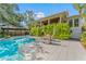 Gorgeous backyard with a sparkling swimming pool, lounging area and lush, mature landscaping at 5010 W Dickens Ave, Tampa, FL 33629