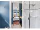Bright bathroom features a glass enclosed shower and opens into a bedroom at 5010 W Dickens Ave, Tampa, FL 33629