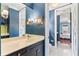 Bright bathroom features a modern sink, neutral countertops, and opens into a bedroom at 5010 W Dickens Ave, Tampa, FL 33629