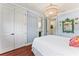 Charming bedroom featuring a decorative chandelier, hardwood floors, and a bright, airy ambiance at 5010 W Dickens Ave, Tampa, FL 33629