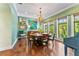 Dining room featuring a round table, hardwood floors, and large windows overlooking the backyard at 5010 W Dickens Ave, Tampa, FL 33629