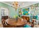 Elegant dining room with hardwood floors, chandelier, and curated decor at 5010 W Dickens Ave, Tampa, FL 33629