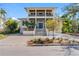 Two-story home with a manicured front yard, well-lit stairs, and a two-car garage at 5010 W Dickens Ave, Tampa, FL 33629