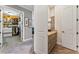 Hallway displaying access to the walk-in closet and a well-appointed bathroom with granite countertops at 5010 W Dickens Ave, Tampa, FL 33629