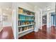 Hallway features stylish shelving with books and beautiful hardwood floors at 5010 W Dickens Ave, Tampa, FL 33629
