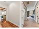 Hallway with hardwood floors and an archway leading to a sunlit living room at 5010 W Dickens Ave, Tampa, FL 33629