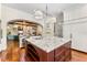 Open concept kitchen with island, wine cooler, stainless appliances, and hardwood floors at 5010 W Dickens Ave, Tampa, FL 33629