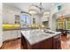 Spacious kitchen with island, white cabinetry, stainless appliances, and views to the backyard at 5010 W Dickens Ave, Tampa, FL 33629