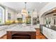 Bright kitchen featuring a large island with marble countertop and views of the dining area at 5010 W Dickens Ave, Tampa, FL 33629