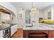 Spacious kitchen with marble island, white cabinets, and stylish lighting at 5010 W Dickens Ave, Tampa, FL 33629