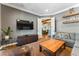 Comfortable living room featuring modern entertainment center, decorative shelves, and neutral color palette at 5010 W Dickens Ave, Tampa, FL 33629