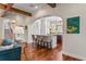 Open-concept living space with hardwood floors, archways, and views of the kitchen and staircase at 5010 W Dickens Ave, Tampa, FL 33629