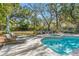 Backyard oasis with pool, spa, fire pit, and ample seating for relaxation and enjoyment at 5010 W Dickens Ave, Tampa, FL 33629