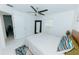 Well-lit bedroom boasts ceiling fan, large window, and stylish mirror at 9404 N 12Th St, Tampa, FL 33612