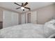 Bedroom with neutral walls, ceiling fan, and double door closet with a white comforter at 1165 Lazy Lake E Rd, Dunedin, FL 34698