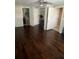 Bedroom featuring polished hardwood floors, ceiling fan, closet, and bathroom access at 11714 Hoyt Ave, Tampa, FL 33617