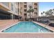 A pristine community pool surrounded by a brick deck and fenced area at 1216 S Missouri Ave # 224, Clearwater, FL 33756