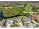 Beautiful aerial view of homes bordering a golf course and waterfront property with mature landscaping and palm trees at 13024 Prestwick Dr, Riverview, FL 33579