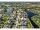 Aerial view featuring waterfront homes on a landscaped street with a nearby golf course, showcasing a well-planned community at 13024 Prestwick Dr, Riverview, FL 33579