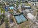 Aerial view of community amenities, including tennis courts, swimming pool and vast green space at 13024 Prestwick Dr, Riverview, FL 33579