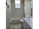 Bright bathroom features a shower-tub combo, toilet, vanity with sink and tile flooring at 13024 Prestwick Dr, Riverview, FL 33579