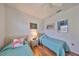 Cozy bedroom has two twin beds, wood flooring, and ceiling fan with a light at 13024 Prestwick Dr, Riverview, FL 33579
