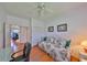 Comfortable bedroom with a ceiling fan, desk, and hardwood floors at 13024 Prestwick Dr, Riverview, FL 33579