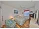 Cozy bedroom features wood flooring, ceiling fan, and comfortable furniture at 13024 Prestwick Dr, Riverview, FL 33579