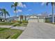 Charming home with a well-maintained lawn, mature landscaping, and a spacious three-car garage, enhancing its curb appeal at 13024 Prestwick Dr, Riverview, FL 33579