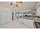 Bright, white kitchen featuring granite counters and a spacious layout open to the dining and living areas at 13024 Prestwick Dr, Riverview, FL 33579