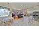 Open kitchen with stainless appliances, granite countertops, and a dining area with views of the pool at 13024 Prestwick Dr, Riverview, FL 33579