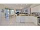 Modern kitchen with white cabinetry, stainless steel appliances, and a breakfast nook overlooking the backyard at 13024 Prestwick Dr, Riverview, FL 33579