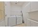 A bright laundry room features white appliances and white cabinets at 13024 Prestwick Dr, Riverview, FL 33579