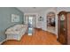 Comfortable living room features wood flooring, a sofa set, and an arched doorway leading to other rooms at 13024 Prestwick Dr, Riverview, FL 33579