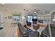Bright living room features hardwood floors, fireplace, and sliding glass doors to the outdoor pool area at 13024 Prestwick Dr, Riverview, FL 33579