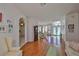 Bright living space featuring wood floors, an arched entrance, and an open layout connecting to the dining area at 13024 Prestwick Dr, Riverview, FL 33579