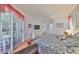 Spacious main bedroom features an ensuite bathroom, large bed, ceiling fan, and sliding glass doors to the porch at 13024 Prestwick Dr, Riverview, FL 33579