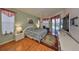 Relaxing main bedroom featuring a large bed, ceiling fan, and sliding glass doors with pool access at 13024 Prestwick Dr, Riverview, FL 33579