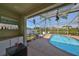 Enjoy a refreshing pool with a screened lanai, bar area, and lush backyard views, perfect for relaxing or entertaining at 13024 Prestwick Dr, Riverview, FL 33579