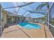 A spacious screened lanai, features a sparkling pool surrounded by ample seating, offering an ideal outdoor retreat at 13024 Prestwick Dr, Riverview, FL 33579