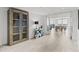 Bright foyer with a display cabinet, console table, and view of the dining area beyond the glass doors at 1660 Gulf Blvd # Ph2, Clearwater Beach, FL 33767