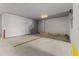 Well-lit garage features painted parking stall with doors for storage at 1660 Gulf Blvd # Ph2, Clearwater Beach, FL 33767