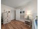 Bedroom with wood-look floors and white furniture at 1883 Brae Moor Dr, Dunedin, FL 34698