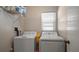 Laundry room with washer, dryer, and storage shelf at 1883 Brae Moor Dr, Dunedin, FL 34698