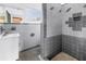 Classic tiled bathroom featuring a sink vanity, mirrored wall, and a walk-in shower at 2028 Blossom S Way, St Petersburg, FL 33712
